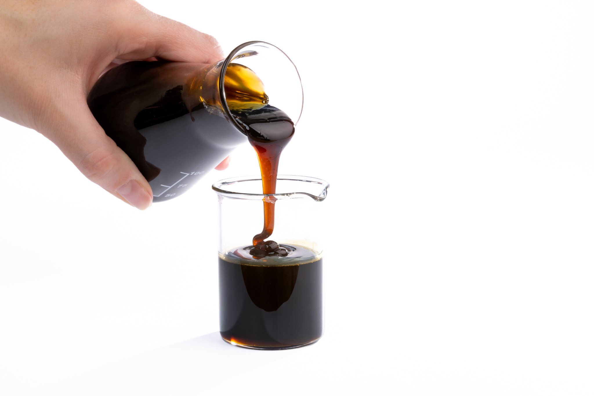 Crude sunflower lecithin being poured into a beaker