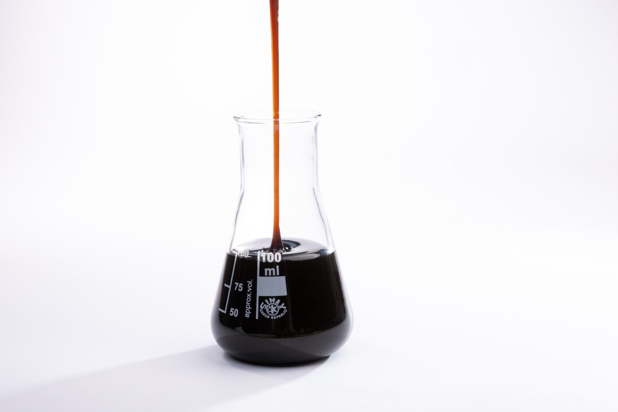 Crude sunflower lecithin stream entering laboratory flask
